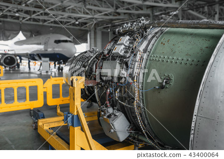 Jet airplane turbine on repairing in hangar 43400064