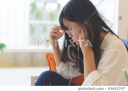 Asian teenager relaxing in library reading book. Asian teenager relaxing in library reading book. 43401747