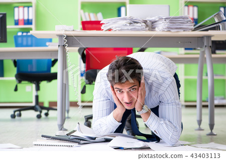 Frustrated businessman stressed from excessive work Frustrated businessman stressed from excessive work 43403113