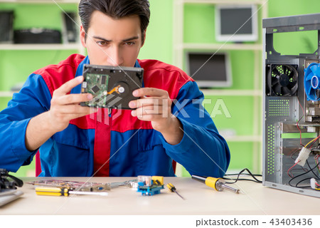 Computer engineer repairing broken desktop Computer engineer repairing broken desktop 43403436