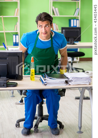 Male spy under cleaner cover stealing confidential documents 43403445