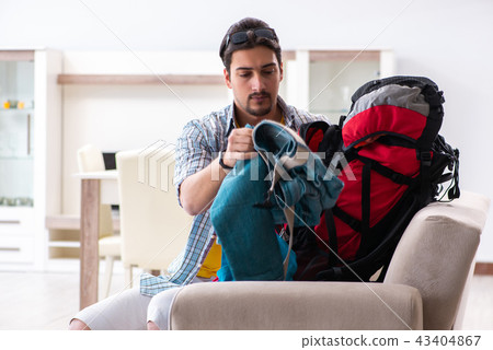 Backpacker packing for his trip 43404867
