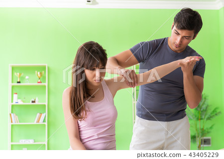 Young doctor chiropractor massaging patient Young doctor chiropractor massaging patient 43405229