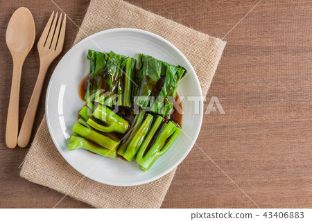 chinese kale with oyster sauce in a ceramic dish. chinese kale with oyster sauce in a ceramic dish. 43406883