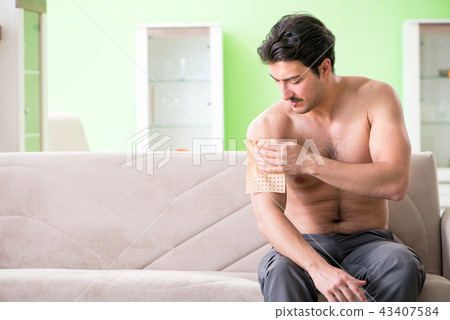 Man applying pepper Capsicum plaster to relieve pain 43407584