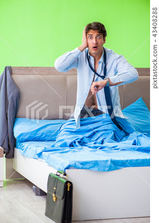 Employee in the bedroom being late for his job  43408288