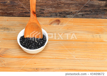 black beans with wooden spoon in bowl black beans with wooden spoon in bowl 43409672