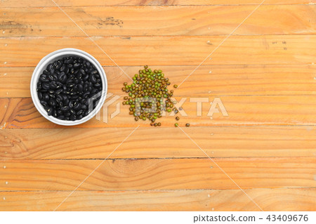 black  beans in bowl and green closeup on wood  43409676