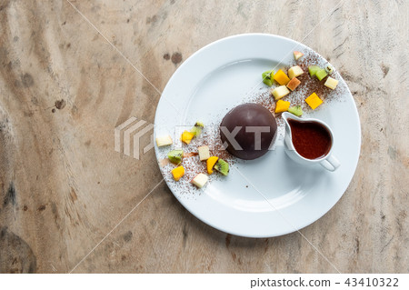 Chocolate cocoa dome dessert with slices fruits 43410322