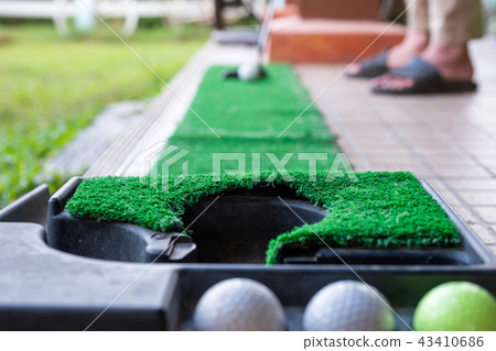 Golfer preparing on training putt with golf ball 43410686