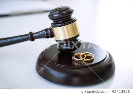 Close up of Judge gavel deciding on marriage divorce and two gol Close up of Judge gavel deciding on marriage divorce and two gol 43413898