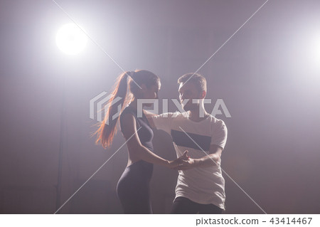 Young couple dancing latin dance Bachata, merengue, salsa. Two elegance pose in dance class Young couple dancing latin dance Bachata, merengue, salsa. Two elegance pose in dance class 43414467