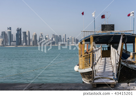 Ladder from Corniche Broadway on Traditional Wooden Boat invite to Gulf City tourist Tour. Beautiful 43415201