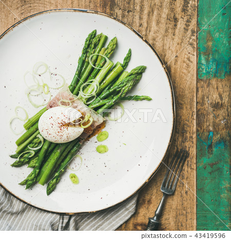 Green asparagus with soft-boiled egg in white plate, square crop Green asparagus with soft-boiled egg in white plate, square crop 43419596