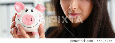 woman hold piggybank in arms 43425756