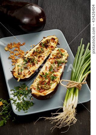 casserole of aubergine cheese and jalapeno peppers on a gray plate casserole of aubergine cheese and jalapeno peppers on a gray plate 43426404