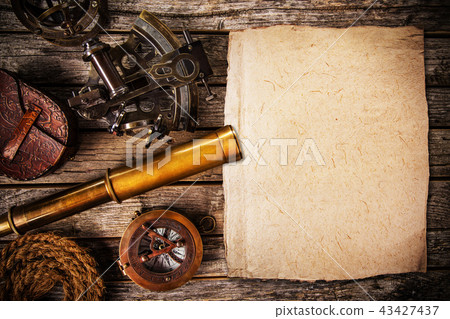 Old vintage navigation equipment with blank paper on wooden table. Old vintage navigation equipment with blank paper on wooden table. 43427437