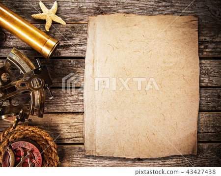 Old vintage navigation equipment with blank paper on wooden table. 43427438