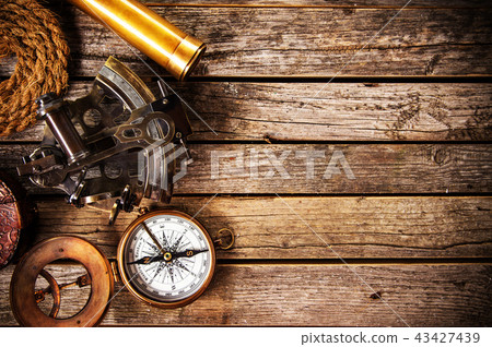 Old vintage navigation equipment on old wooden background. Old vintage navigation equipment on old wooden background. 43427439