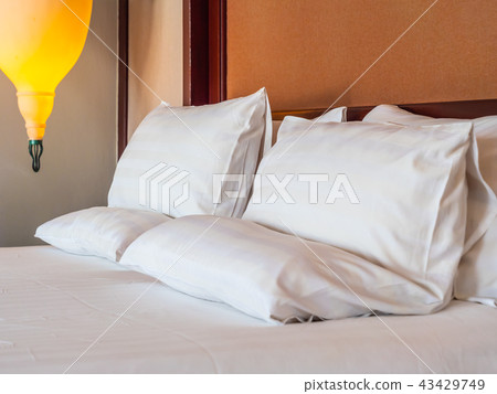 Comfortable pillow on bed decoration in hotel bedroom Comfortable pillow on bed decoration in hotel bedroom 43429749