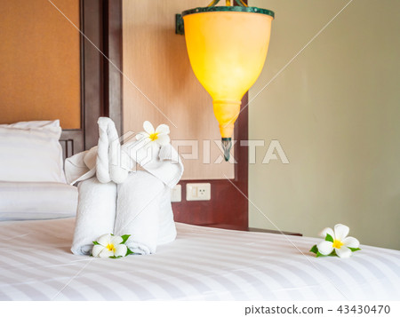 White elephant towel and comfortable pillow on bed White elephant towel and comfortable pillow on bed 43430470