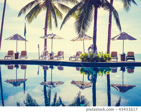 Umbrella and chair around luxury outdoor swimming pool Umbrella and chair around luxury outdoor swimming pool 43431617