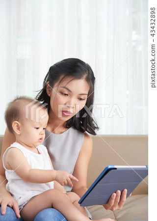 Woman showing something interesitng to kid 43432898
