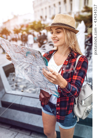 Woman exploring map on street 43434317