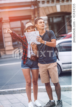 Couple with map orientating on street Couple with map orientating on street 43434335