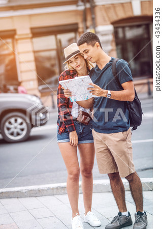 Couple reading map on street Couple reading map on street 43434336