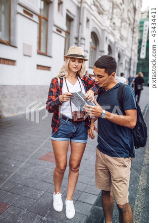 Stylish couple with map on street Stylish couple with map on street 43434411