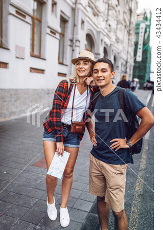 Casual couple of travelers on street Casual couple of travelers on street 43434412