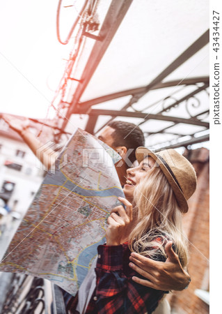 Laughing couple exploring city  43434427