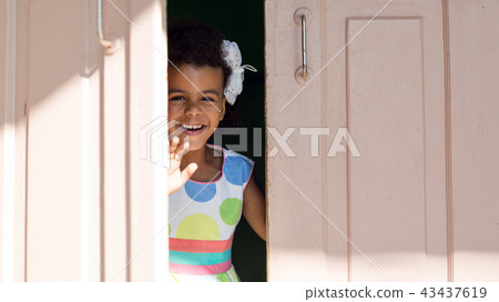 The black girl smiles in the doorway. The black girl smiles in the doorway. 43437619