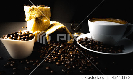 A cup of coffee on a black table 43443350