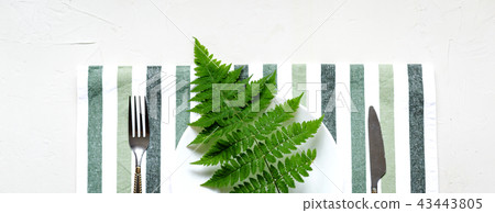 Tablesetting in white and green colors.Holiday 43443805