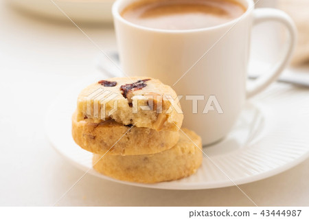 A cup of coffee with homemade cookies on a white background. A cup of coffee with homemade cookies on a white background. 43444987