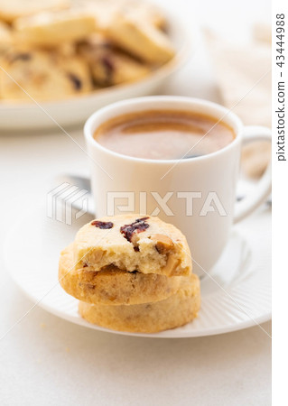 A cup of coffee with homemade cookies on a white background. 43444988