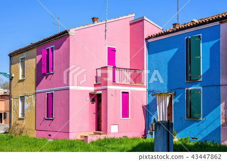 Daylight view to vibrant pink and blue houses Daylight view to vibrant pink and blue houses 43447862