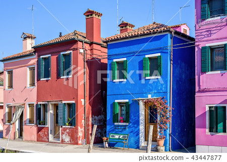 Daylight view to vibrant colorful houses facades 43447877