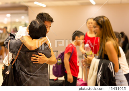 Son hugging mother on arrival in the airport Son hugging mother on arrival in the airport 43451015