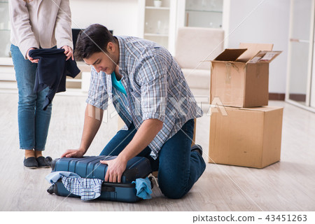 Woman evicting man from house during family conflict 43451263