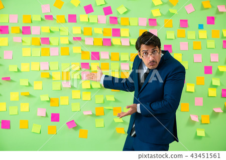 Businessman with many business priorities Businessman with many business priorities 43451561