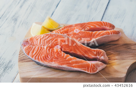Raw trout steaks on the wooden board Raw trout steaks on the wooden board 43452616