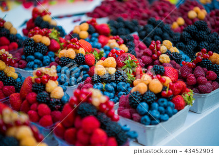 Fresh different berries in the plastic cup at Europe dong street berries and exotic fruits at market 43452903