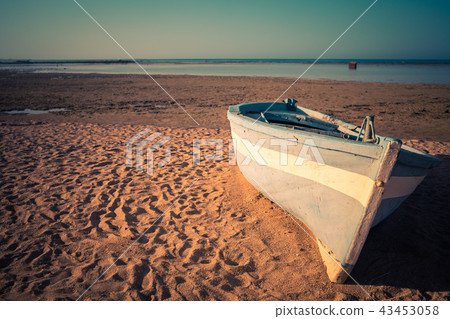 Tropical Seascape with a fishing boat on beach 43453058