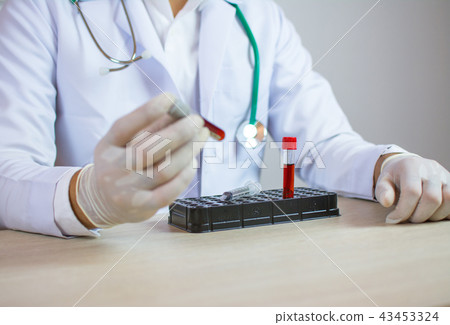 doctor holds a blood sample tube in his hand testi 43453324