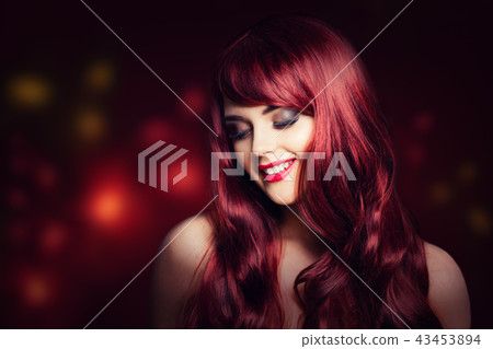 Redhead woman with long red curly hairstyle Redhead woman with long red curly hairstyle 43453894