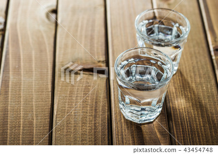 Vodka in shot glass. Vodka in shot glass. 43454748
