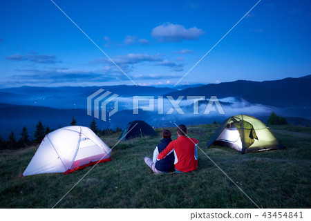 Back view, loving people sitting near camping enjoying sunrise in mountains 43454841